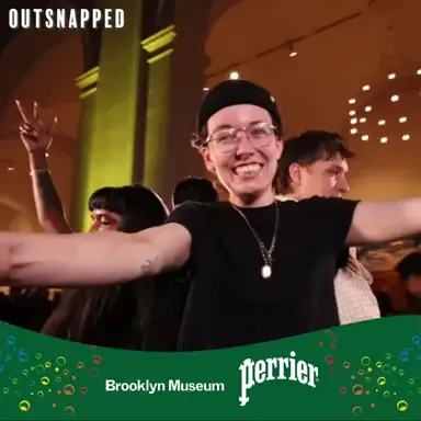 360 Video Booth in Action — Event Spin Guest with arms outstretched smiling during 360 video booth spin at Brooklyn Museum Perrier event