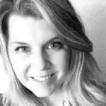 Angela Wagner - Testimonial Portrait Woman with long hair smiling in black and white portrait