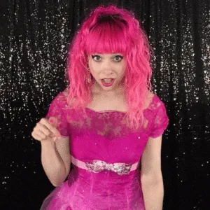 Exaggerated Expression Boomerang Technique Woman with pink wig and open-mouth surprised expression, hand at waist