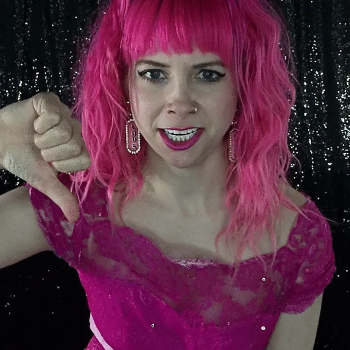 Boomerang Photo Booth Selfie Pose Example Woman in bright pink wig and magenta dress giving thumbs down gesture against black sequin backdrop