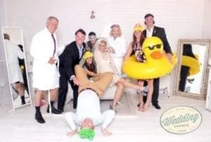 Wedding shower group photo with silly duck prop Bridal party posing with oversized yellow duck prop in photo booth