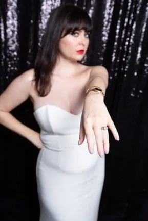 Bride in white strapless dress against black sequined backdrop