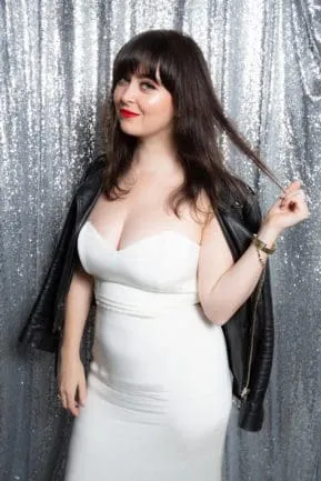 Bride in white formal gown with black shawl against silver sequined backdrop