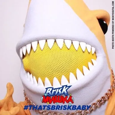 Brisk Brikk character with exaggerated white mouth and yellow spiky teeth, promotional image for branded photo booth activation