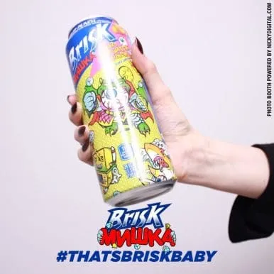 Hand holding colorful Brisk Samba beverage can with cartoon character graphics