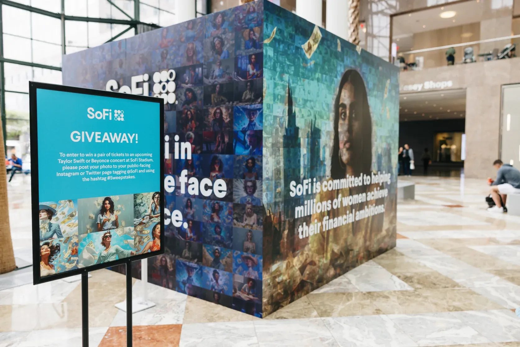 SoFi branded photo mosaic wall and giveaway signage at an OutSnapped activation in Brookfield Place