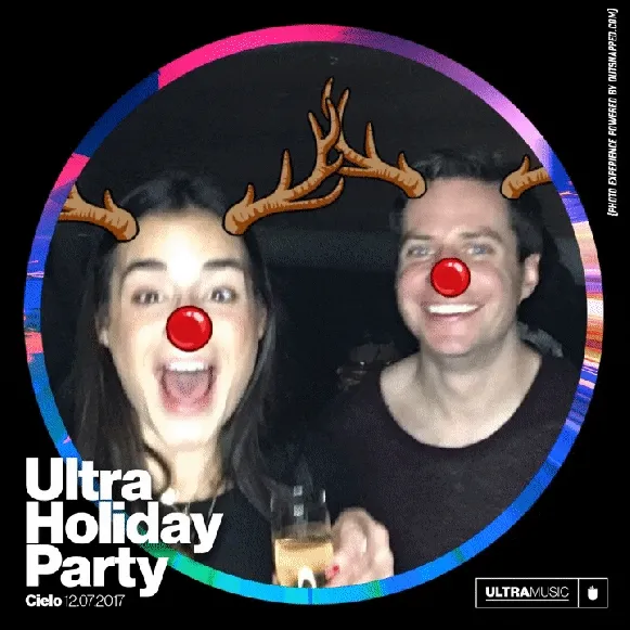 Couple with photo booth reindeer antlers and Rudolph nose filters
