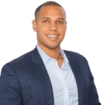 Darnell Holloway - Testimonial Headshot Man in dark blue blazer and light blue dress shirt smiling professionally