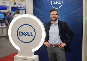 Man in business attire posing at Dell brand activation booth