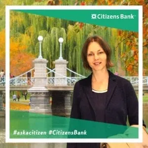 Female attendee smiling in Citizens Bank booth with decorative garden virtual background