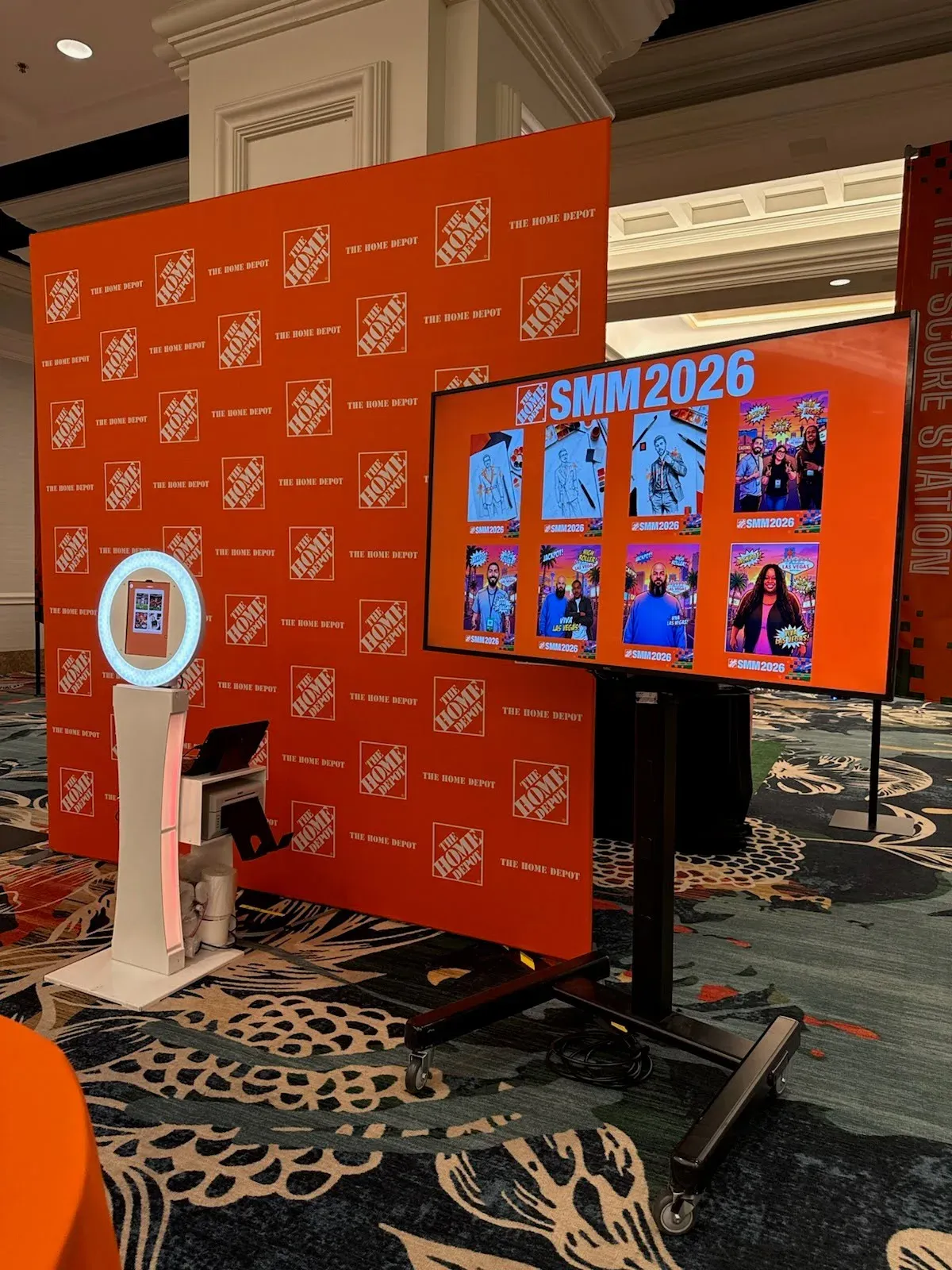 OutSnapped FutureFoto photo booth set up on a branded backdrop at a Hartmann corporate event
