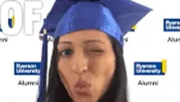 Graduate in blue cap and gown smiling at camera, wearing Ryerson University alumni regalia