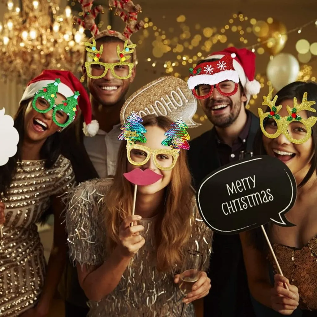 Holiday Photo Booth Props & Party Fun Five people wearing festive holiday photo booth props including light-up glasses, Santa hats, and reindeer antlers at a Christmas party, holding props with a gold bokeh background.