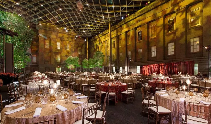 Kogod Courtyard Formal Gala Dinner Setup Formal gala dinner setup with round tables in modern courtyard surrounded by historic brick building facades