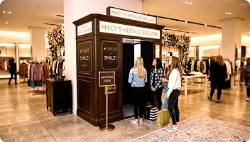 Long-term Macy's Herald Square photo booth installation Macy's Herald Square photo booth in department store with customers queuing