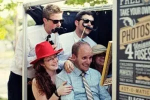 Guests enjoying Magbooth photo booth with props and accessories