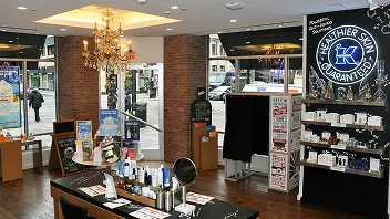 MagBooth retro photo booth installed in upscale retail boutique with brick walls, crystal chandelier, and luxury product displays
