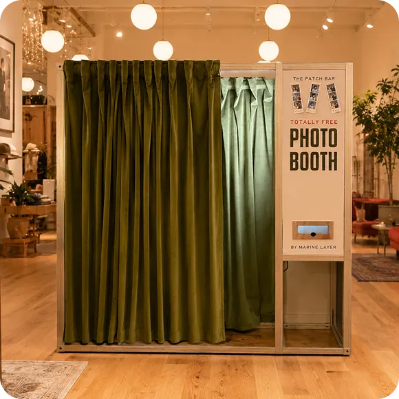 Marine Layer MagBooth custom installation Marine Layer branded photo booth installed at retail location with green velvet curtains