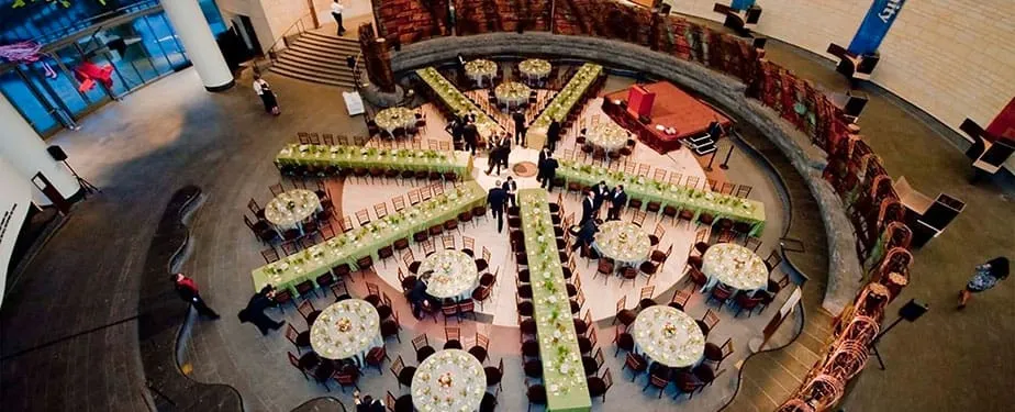 National Museum of American Indian Event Space Aerial View Overhead view of the National Museum of the American Indian's circular event space in Washington, D.C., with round tables set for a corporate dinner and green-lined seating areas
