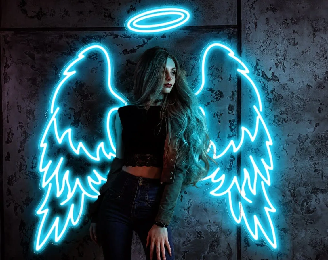 Custom Neon Angel Wings Photo Booth Backdrop Woman posing in front of neon angel wings and halo backdrop, a custom photo booth setup with bright cyan LED lighting