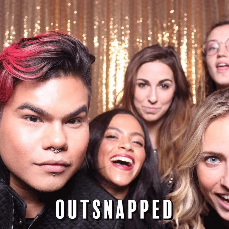 Five guests smiling and laughing in front of a gold sequin backdrop at an OutSnapped photo booth