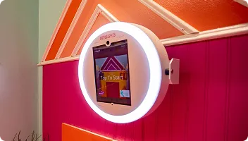 OutSnapped photo booth with white ring light installed on vibrant magenta wall