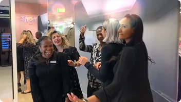In-store guest engagement moment Group of guests enjoying photo booth experience inside retail activation space