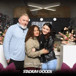 Stadium Goods In-Store Photo Booth Activation Three people posing together at a Stadium Goods retail photo booth with Mother's Day branding and floral backdrop