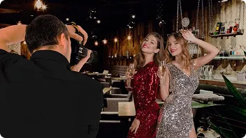 Professional Roaming Photography in Action Photographer capturing event guests in elegant attire at upscale venue