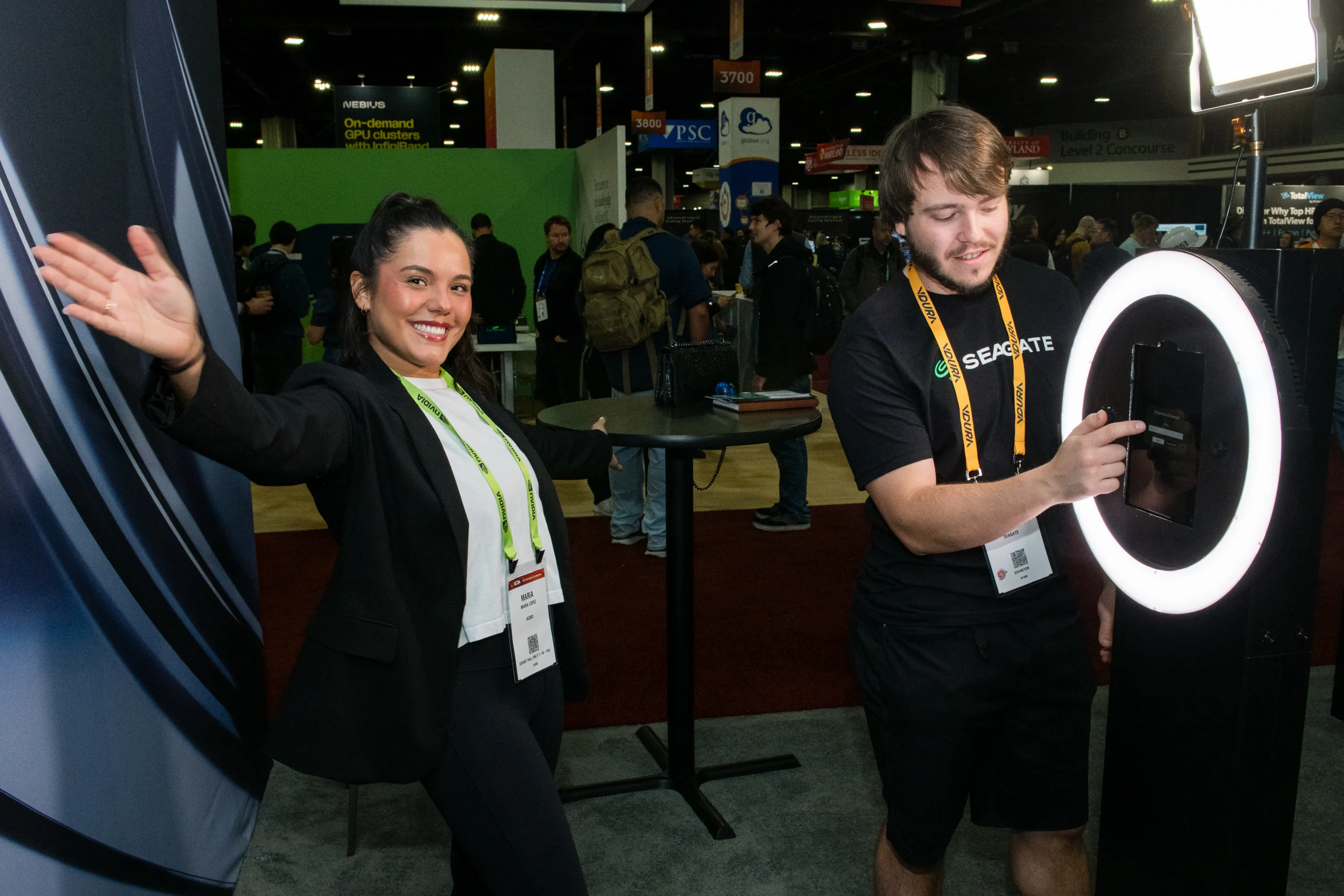 Seagate Trade Show Photo Booth with Ring Light Trade show attendees using a Seagate branded photo booth with ring light, capturing photos on the expo floor — Outsnapped trade show photo booths.