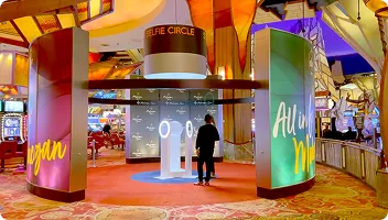 Selfie Circle Entertainment Venue Installation Colorful branded photo booth installation at entertainment venue with neon signage and interactive displays