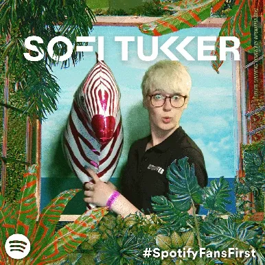 Sofi Tukker Treehouse Tour Photo Booth Experience Sofi Tukker member wearing glasses and black shirt holding red and white striped prop in OutSnapped photo booth at Treehouse Tour event