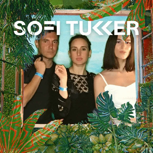 Group Photo Booth Experience at Sofi Tukker Tour Three members of electronic music duo Sofi Tukker pose together in an OutSnapped photo booth frame decorated with tropical foliage and colorful geometric patterns