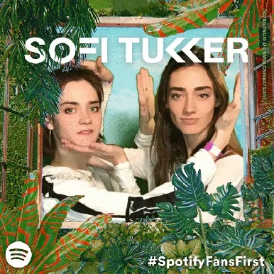 Interactive Photo Booth Props and Styling Sofi Tukker duo posing in OutSnapped photo booth with tropical leaf props and white accessories against treehouse-themed backdrop