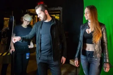 Couple at FutureFoto Treehouse Tour Photo Booth Sofi Tukker members and fan posing together at OutSnapped photo booth during Treehouse world tour stop, with green screen backdrop visible