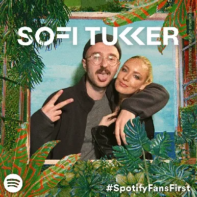 Interactive Photo Booth Moment with Props Sofi Tukker duo posing together in OutSnapped photo booth with tropical leaf frame and blue background for Treehouse Tour