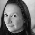Stephanie Necel - OutSnapped Customer Success Story Woman with dark hair in professional black and white headshot portrait