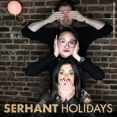 Three people stacking vertically with silly expressions at photo booth