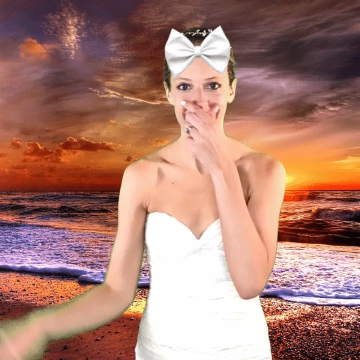 Bride with sunset beach green screen effect Woman in white strapless dress and oversized bow headpiece posing with hand to mouth against digitally composited sunset beach background