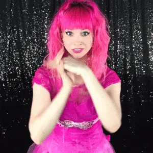 Woman Posing with Arms Crossed Woman with pink wig and dress posing with arms crossed against backdrop