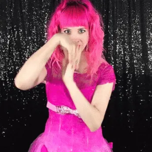 Woman with Playful Face Touch Woman with pink wig playfully touching her face against sparkly backdrop