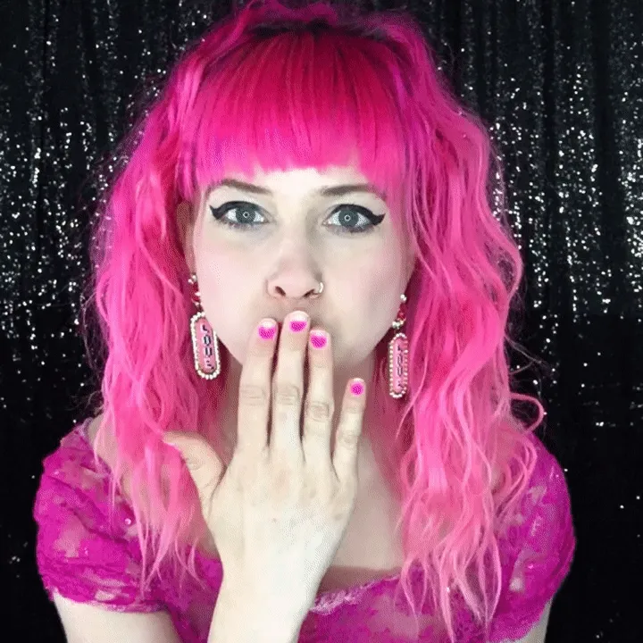 Woman in Pink Wig and Sparkly Nails Woman in hot pink wig with matching nails against glittery backdrop