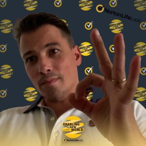 Selfie of a man in a virtual photo booth with Norton branded background