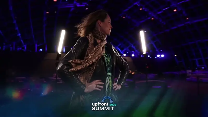 a woman in a black jacket and scarf