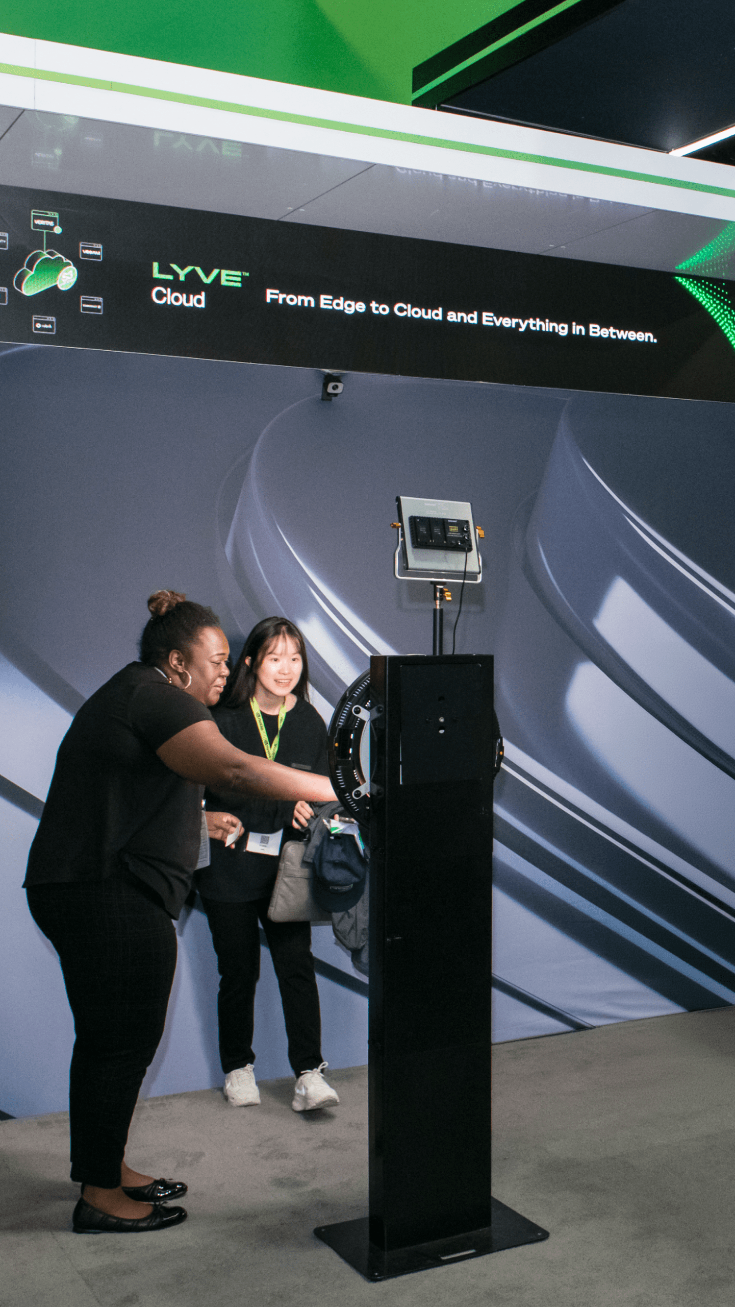 Attendees engaging with AI photo booth at trade show conference floor