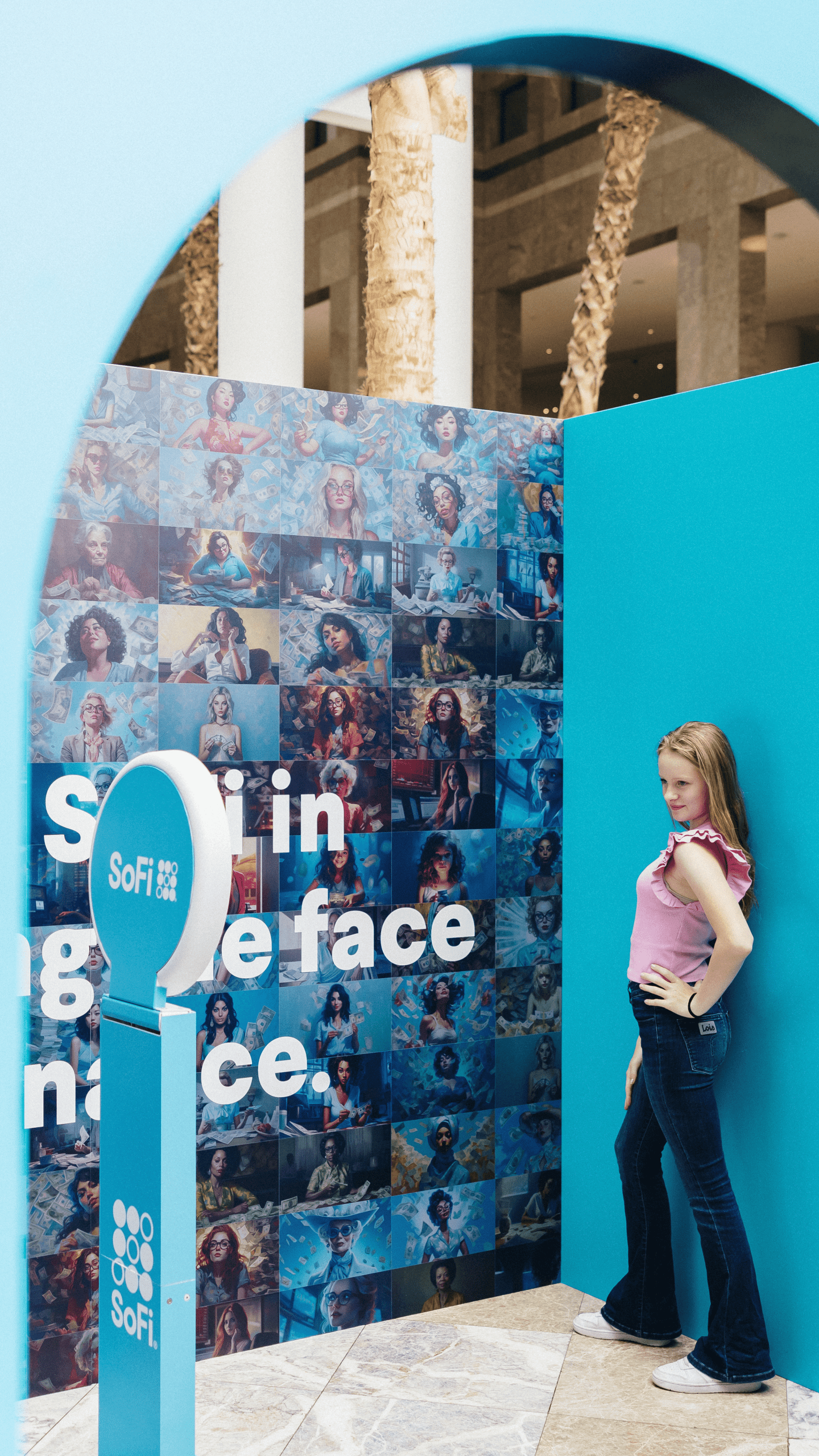 Woman posing at SoFi branded AI photo booth during product launch activation