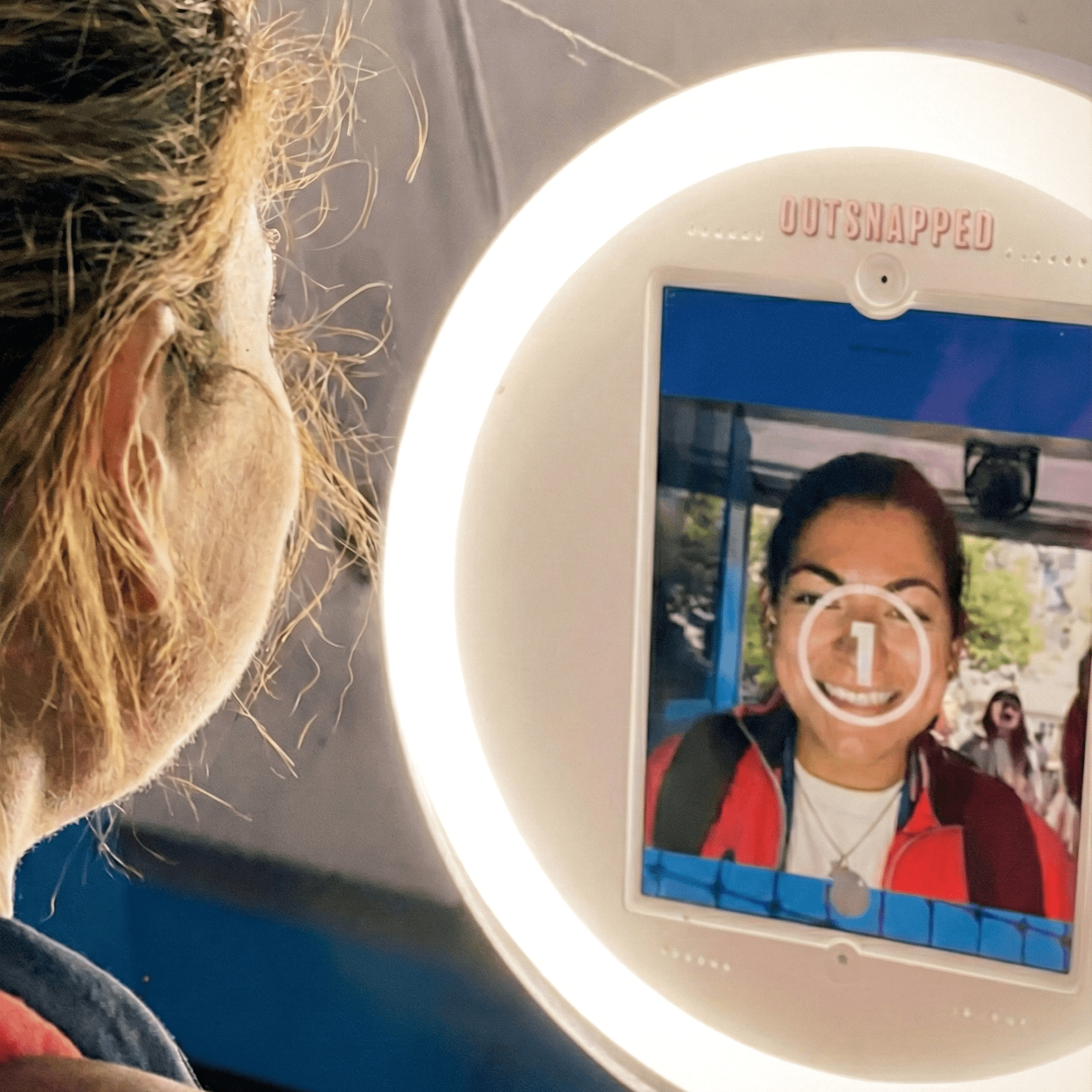 Guest posing at AI photo booth ring light station at US Open event