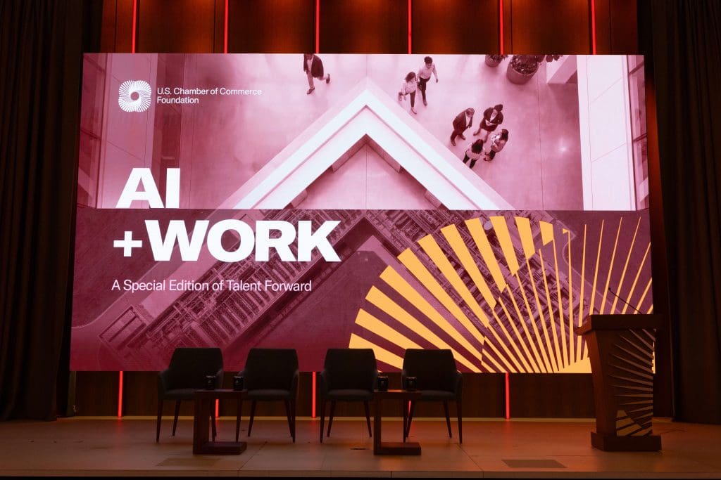 The Future of Event Engagement Is Personalization, Not Automation 3 Empty stage with AI and Work Summit branding screen at the US Chamber of Commerce Foundation event